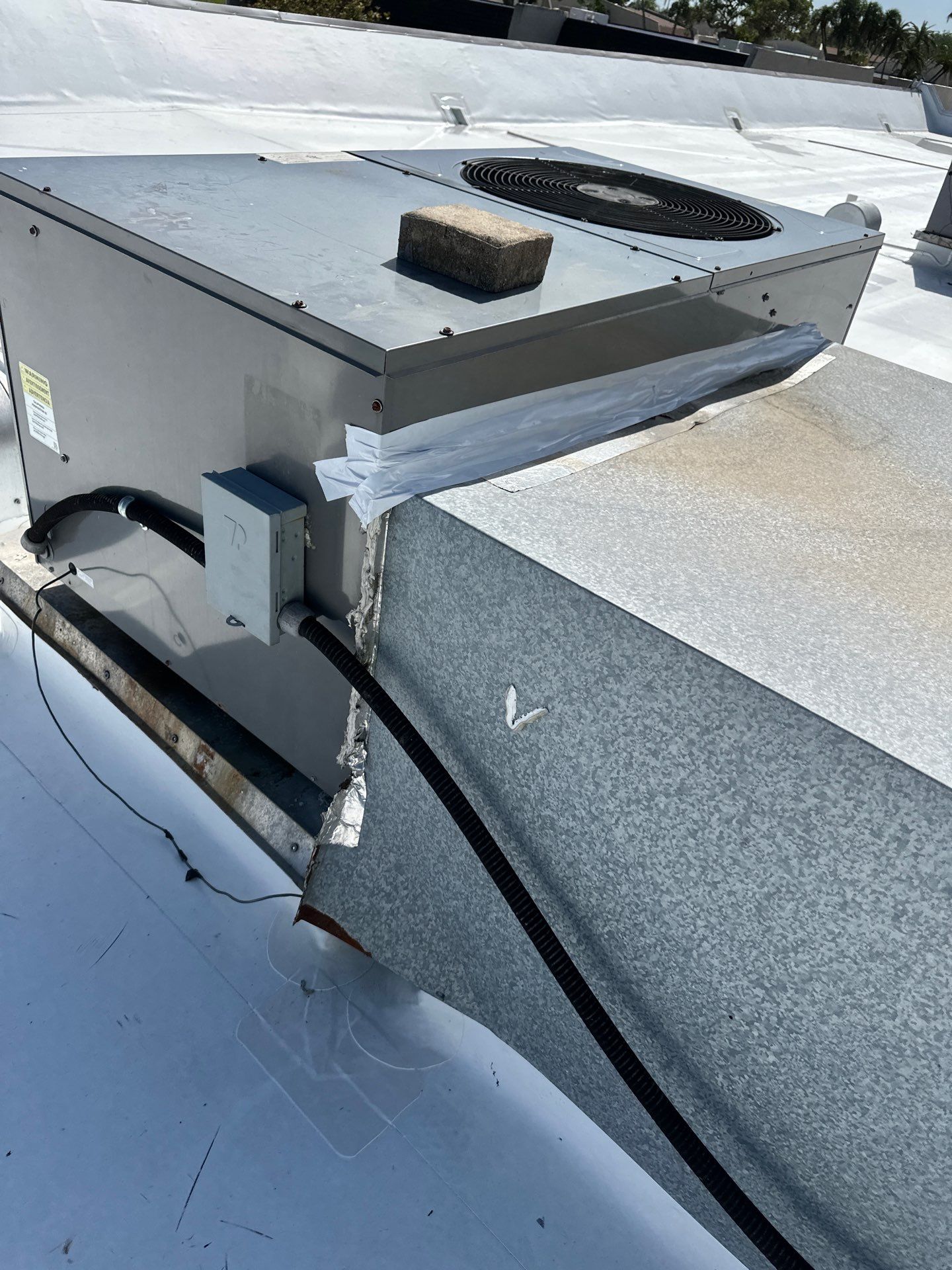 Aerial perspective view of building complex with professional roofing