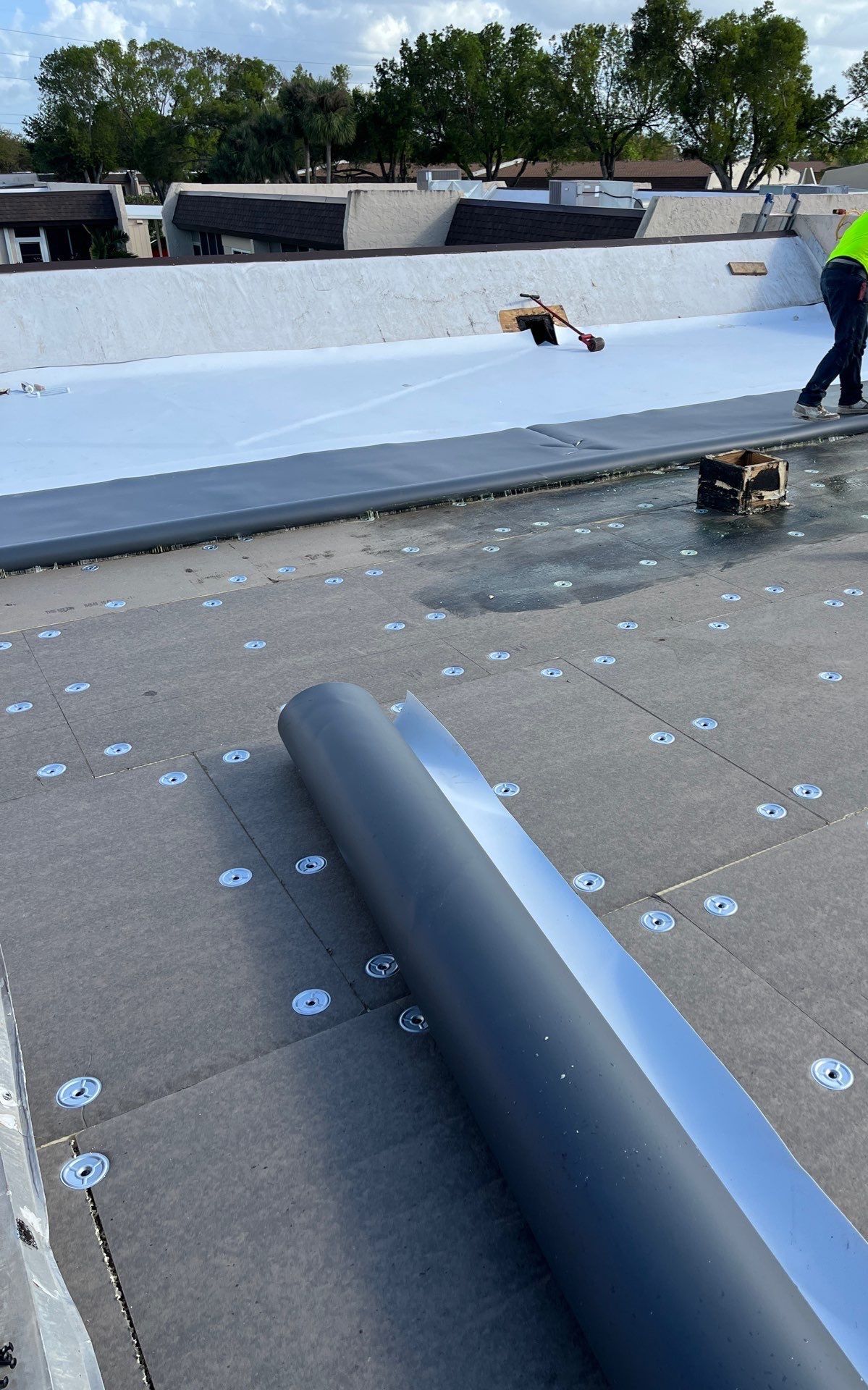 Aerial view of building complex showing comprehensive roofing work