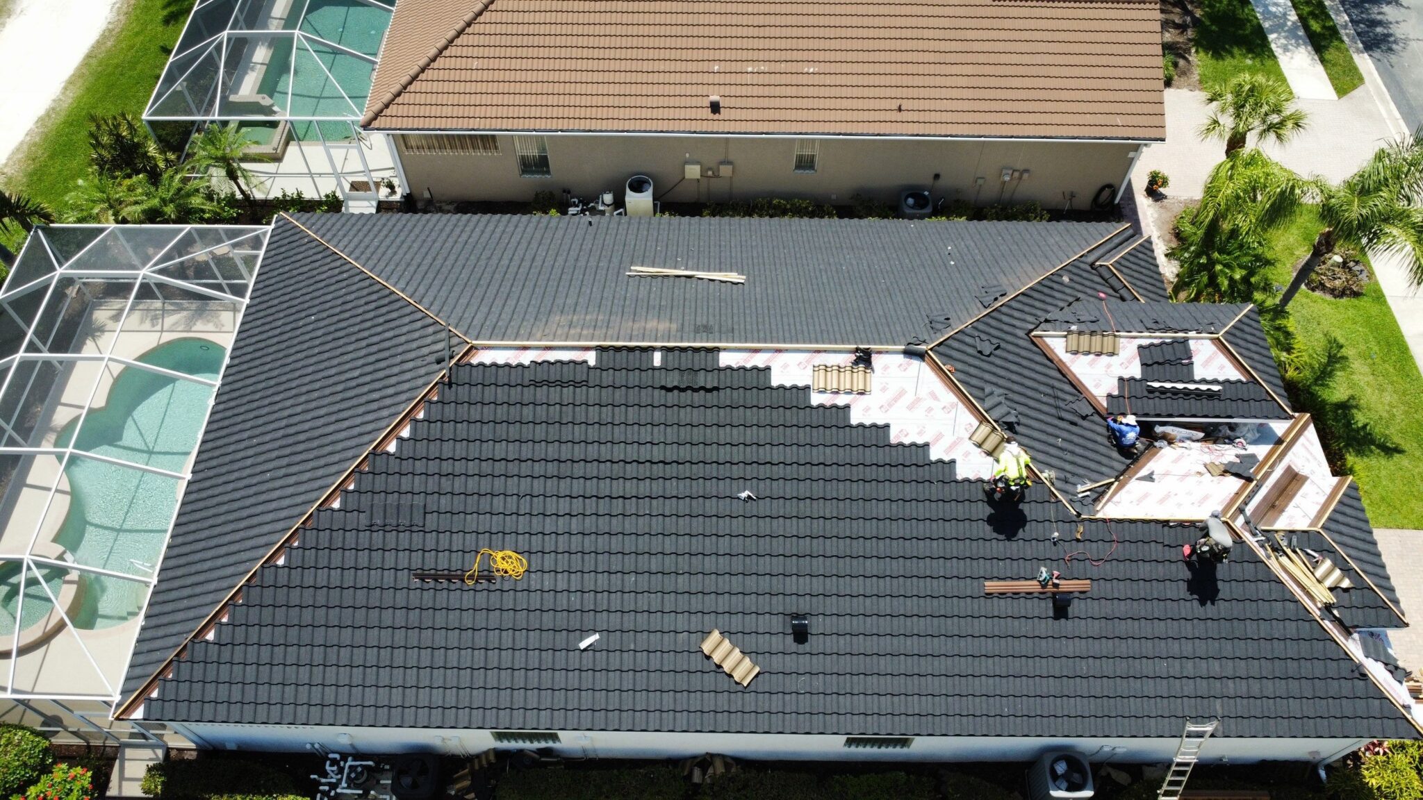 Shingle roof installation progress from aerial perspective