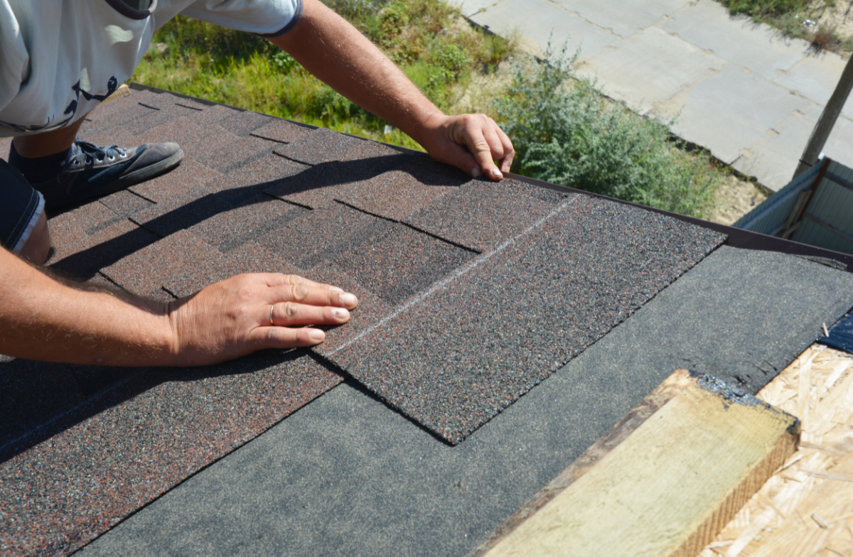Professional roofer installing premium shingles