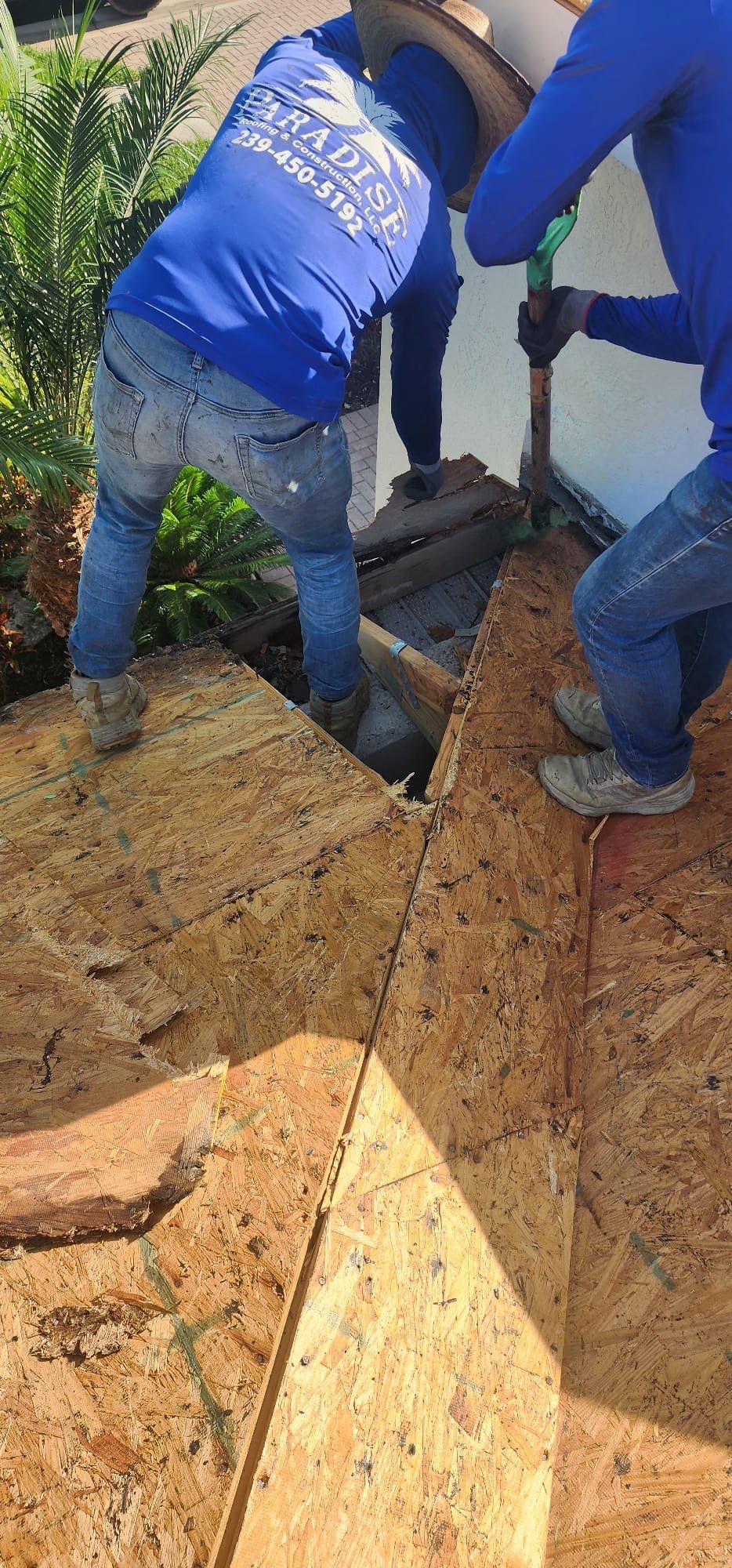Team members coordinating complex roofing installation