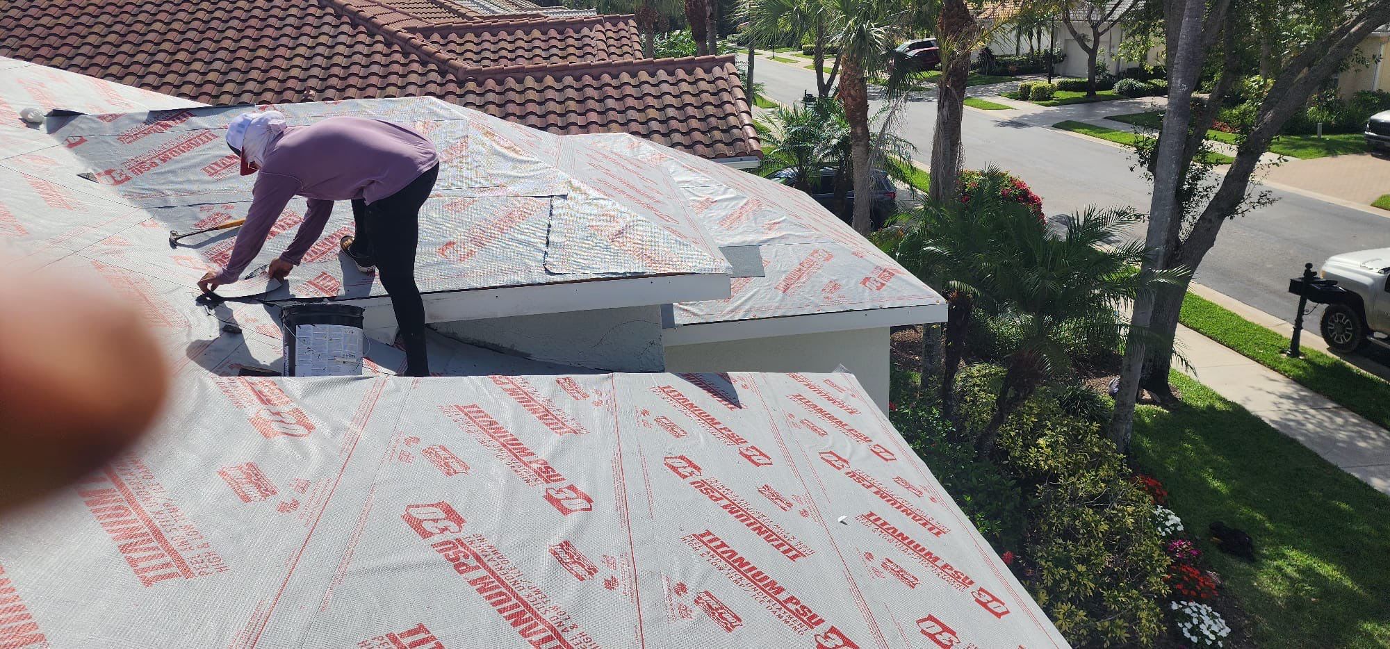 Workers installing roof underlayment professionally